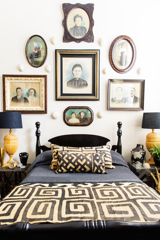 Daniel Mathis combines antiques and vintage items with more contemporary pieces such as these antique photos and prints with contemporary bedding